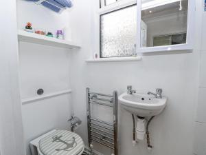 a white bathroom with a sink and a toilet at Red Brick Haven in East Cowes +27 photos