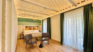 a bedroom with a bed and a table and chairs at Hotel Doho in Málaga +25 photos