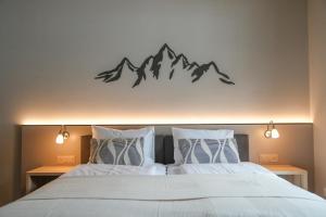 a bedroom with a bed with mountains on the wall at Studio 54 Davos in Davos