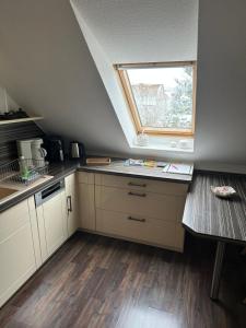 a kitchen with white cabinets and a window in it at Am Oberpark in Bad Muskau