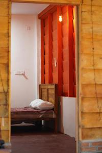 a small room with a bed and a wooden door at Beach View Resort in Batticaloa