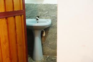 a bathroom with a sink and a toilet at Beach View Resort in Batticaloa
