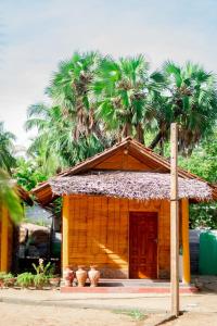 a small house with palm trees on top of it at Beach View Resort in Batticaloa +17 photos