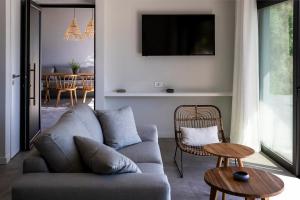 a living room with a couch and a table at Villa Helena in Paleros
