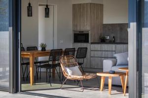 a living room with a table and chairs and a couch at Villa Helena in Paleros