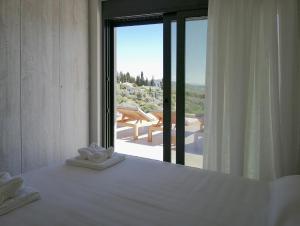 a bedroom with a bed with a view of the ocean at Villa Helena in Paleros +31 photos
