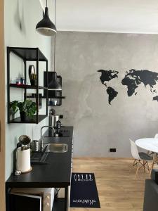 a kitchen with a map of the world on the wall at Apartament Kołobrzeska in Piła