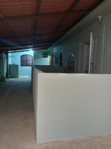 a white wall in a room with a building at Casa três com cozinha americana in Araruama