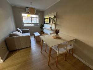 a living room with a table and a couch at Regia Haus - Villa Sarita I in Posadas