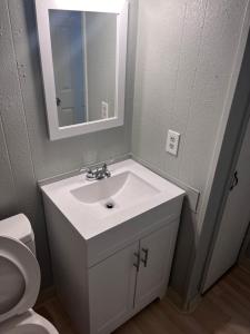 a bathroom with a white sink and a toilet at Heavenly Home in Monroe +6 photos