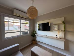 a living room with a tv and a window at Regia Haus - Villa Sarita I in Posadas +37 photos