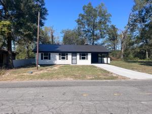 a small white house with a black roof at Heavenly Home in Monroe