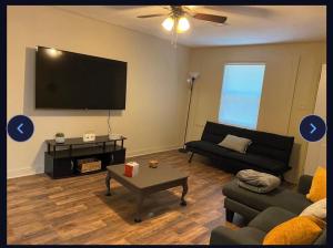 a living room with a couch and a flat screen tv at Heavenly Home in Monroe