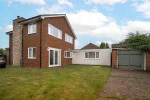 a brick house with a garage in a yard at Contractor Accommodation, Free Large Car Park, Sleeps 7 in Kent
