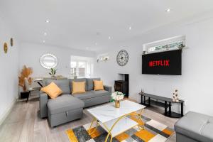 a living room with a couch and a table at Contractor Accommodation, Free Large Car Park, Sleeps 7 in Kent