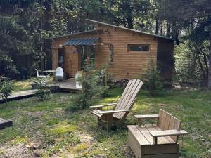 a log cabin with two chairs and a bench at Domaine de la Mamounette in Champclause +29 photos