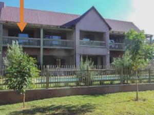 a house with a fence in front of it at The Lofts in Hoedspruit