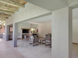 a person sitting at a table in a living room at The Lofts in Hoedspruit