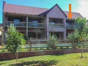 a house with a fence in front of it at The Lofts in Hoedspruit +8 photos