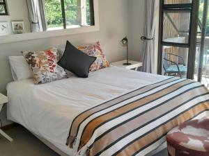 a bed with pillows on it in a bedroom at The Lofts in Hoedspruit