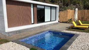 a swimming pool in a yard next to a house at Dusk batroun in Batroûn +2 photos