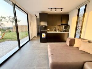 a living room with a couch and a kitchen at Dusk batroun in Batroûn