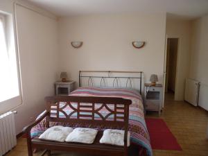 a bedroom with a bed with two pillows on it at Gîte de la Grosse Planche in Férolles