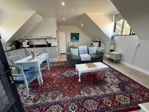 a living room with a couch and a table at Stoneridge farm in Plettenberg Bay
