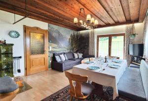 a living room with a table and a couch at Almliesl KRIS-750 in Krispl