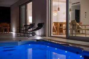 a house with a swimming pool and a dining room at Jadrija Luxury Vacations Apt1 in Šibenik