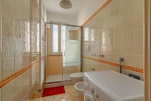a bathroom with a toilet and a shower and a sink at Casetta Di Denny in Polignano a Mare