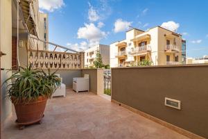 an apartment balcony with a plant on a balcony at Casetta Di Denny in Polignano a Mare