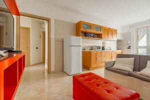 a kitchen and living room with a white refrigerator at Casetta Di Denny in Polignano a Mare