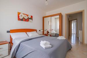 a bedroom with a bed with towels on it at Casetta Di Denny in Polignano a Mare