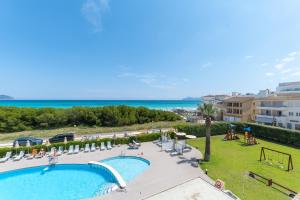 an image of a swimming pool at a resort at Aparthotel Dunes Platja in Can Picafort