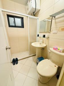 a bathroom with a toilet and a sink at Frank B&B in Jincheng +79 photos