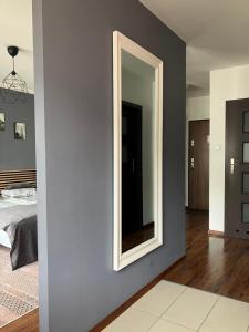 a bedroom with a large mirror on the wall at Szybowników 2 in Piła