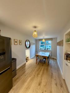 a kitchen and dining room with a table at Unique Vicarage Town Cottage in Leominster