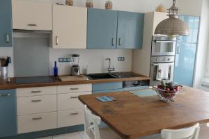 a kitchen with a table with a bowl of fruit on it at La Maison d'Adonis à la mer in Crozon