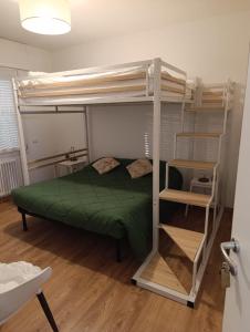 a bedroom with a bunk bed with a green comforter at DESDEMA & OPERA Rooms in Quinto di Treviso