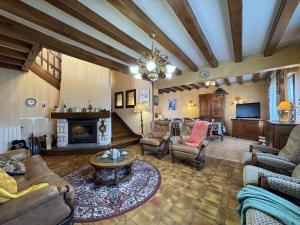 a living room filled with furniture and a fireplace at La Changéenne - Maison de charme - 12 pers in Changé