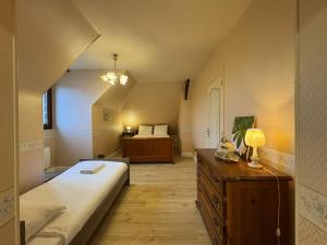 a small room with a bed and a bedroom with a bed istg at La Changéenne - Maison de charme - 12 pers in Changé