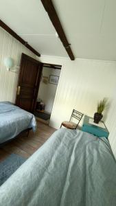 a bedroom with a bed and a table and a chair at Charming apartment with two bedroms and beautifull sea view in Fauske in Fauske