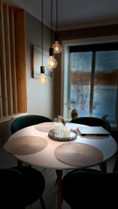 a white table with chairs and candles on it at Charming apartment with two bedroms and beautifull sea view in Fauske in Fauske +49 photos