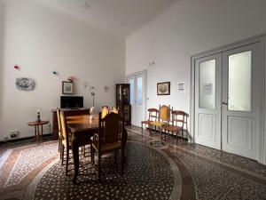 a dining room with a table and chairs at Hostello Genovese in Genoa