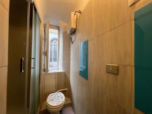 a bathroom with a toilet and a window at Hostello Genovese in Genoa +90 photos