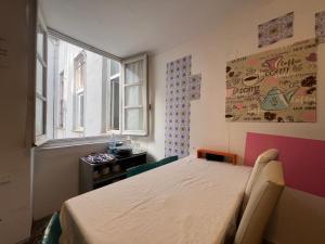 a bedroom with a bed and a window at Hostello Genovese in Genoa