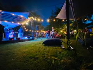 a group of people standing in a park at night at Le Grand Bain in Marciac