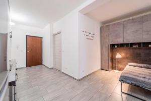 a large room with a bed and a closet at Monolocale Giulio Cesare in Novara