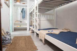 a bedroom with two bunk beds and a ladder at Ampio Trilocale sul Golfo di Marinella in Santa Marinella